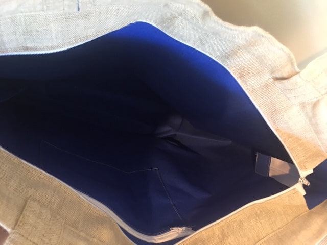 This bag is lined in blue with an interior zipper pocket to hold small items. 